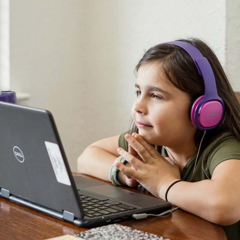 A middle-school student receiving one-to-one guidance at a computer.