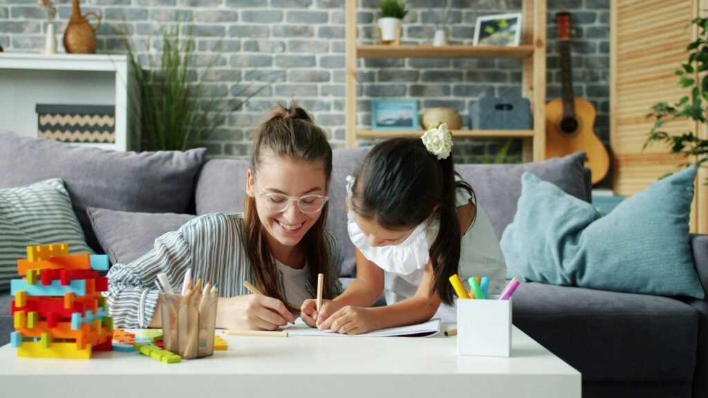 A tutor sitting with a student during a lesson.